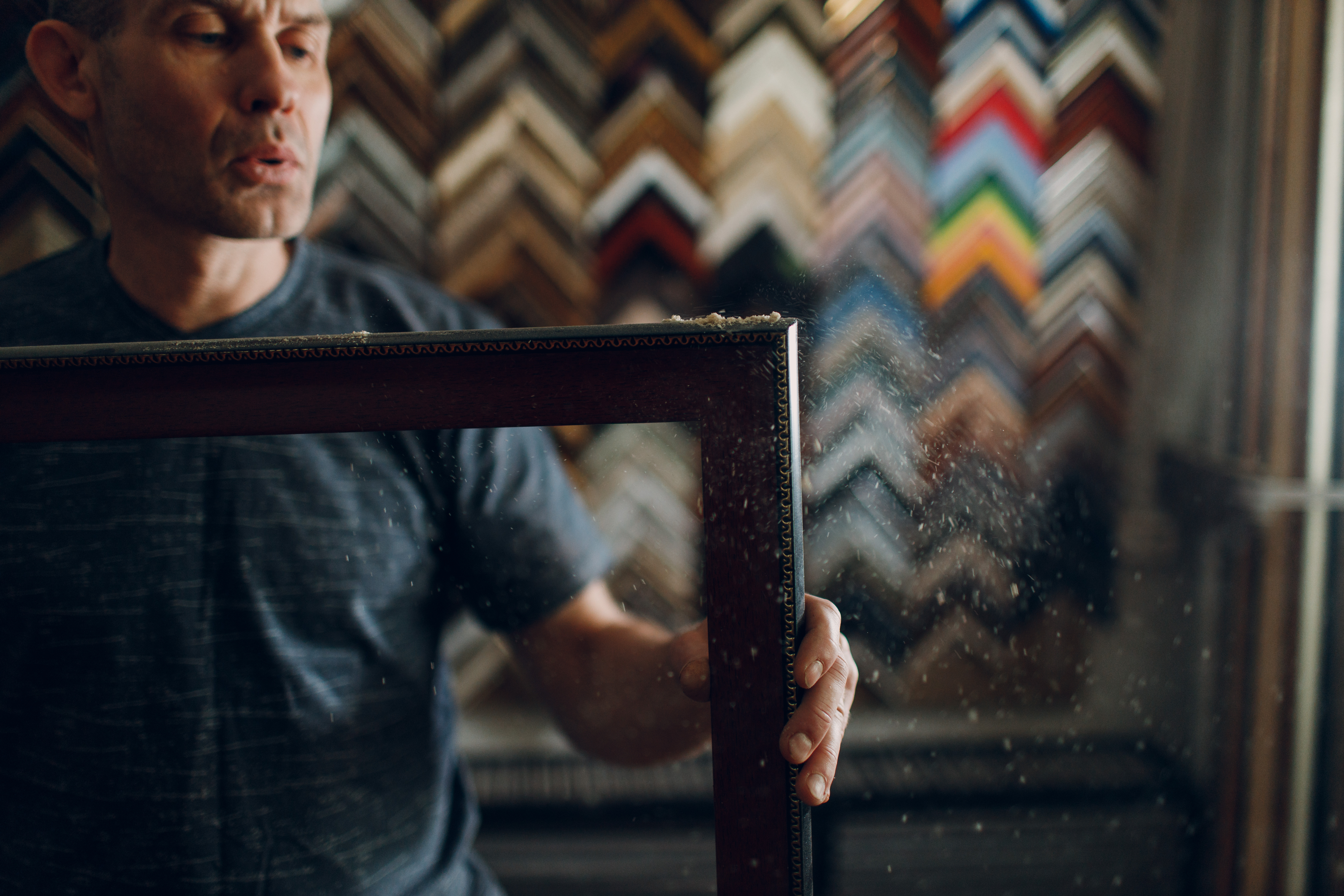 A craftsperson carefully working on a custom frame